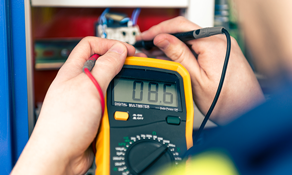 Electrician checking voltage with a multimeter